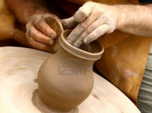 9657500-close-up-on-potters-hands-making-clay-jug (13K)