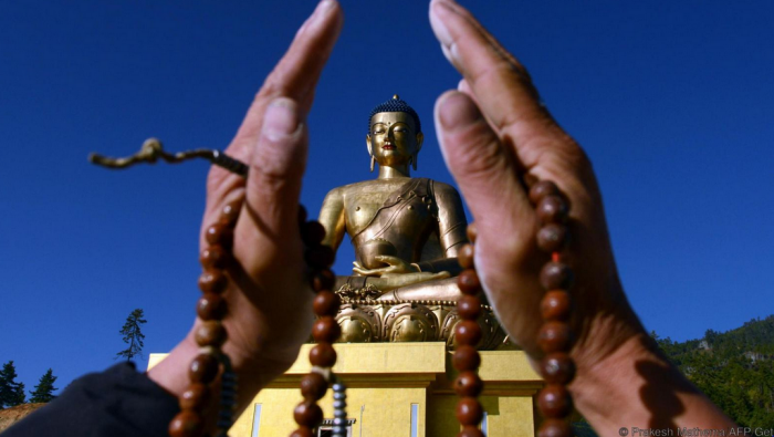 A devotee before the Buddha Dordenma statue in Thimphu-Credit-robertchaen (367K)