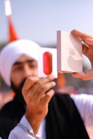 Player reading the message of Guru Nanak through the lens in card game.jpg