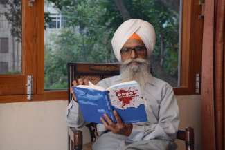 Dr Rajinder Singh reading the Book Drug Addiction.jpg