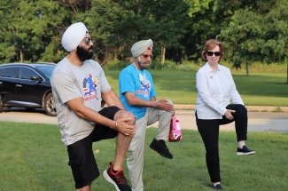 Oneness Run-Walk_2021_Dr. Kapoor Rajinder Singh Mago Stretching with _IL State Senator Ann Gillespie.jpg