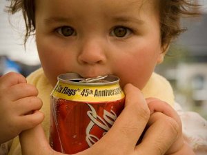 Baby drinking a Coke
