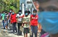 The Migrant labours stand in queue to get their lunch at Gurunanak college in Velachery. (Photo | Ashwin Prasath, EPS)