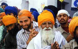 Sikhs greeting us as the procession passes.