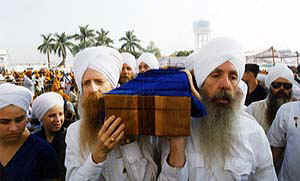 Dr. Soram Singh & Harbhajan Singh in the front carrying the sword up to Keshghar Sahib